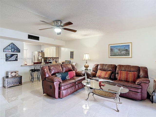 8635 NW 8th St Unit 103, Miami, FL 33126 - living area with ceiling fan, a textured ceiling, and light marble finish flooring