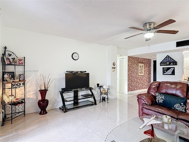 8635 NW 8th St Unit 103, Miami, FL 33126 - living area featuring a ceiling fan, a textured ceiling, and brick wall