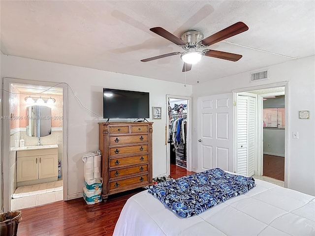 8635 NW 8th St Unit 103, Miami, FL 33126 - bedroom with wood finished floors, a closet, ensuite bath, a walk in closet, and ceiling fan