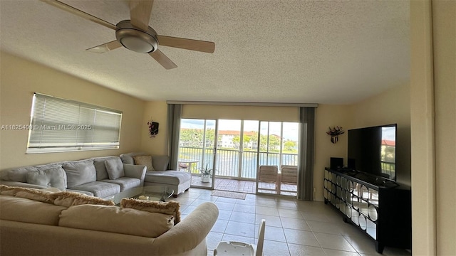 12950 SW 13th St Unit 301D, Pembroke Pines, FL 33027 - living area featuring light tile patterned floors, ceiling fan, and a textured ceiling