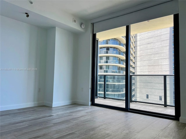 45 SW 9th St Unit 3602, Miami, FL 33130 - unfurnished room with floor to ceiling windows, healthy amount of natural light, and wood finished floors