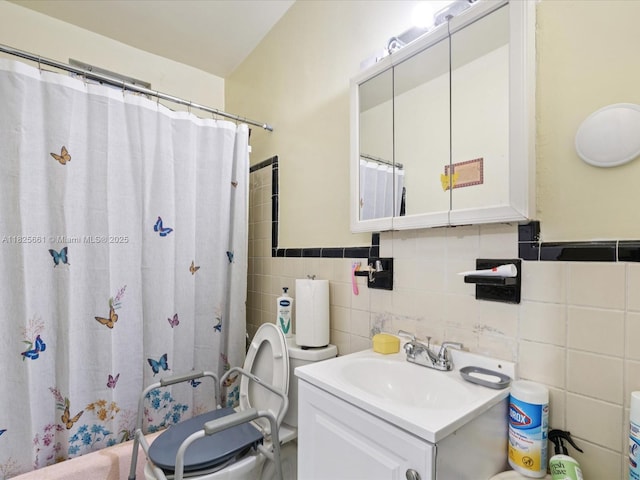 3490 Charles Ave, Miami, FL 33133 - bathroom with tile walls, vanity, a shower with shower curtain, and a wainscoted wall