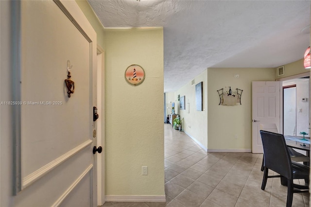 7100 NW 17th St Unit 402, Plantation, FL 33313 - hallway featuring a textured ceiling and light tile patterned floors
