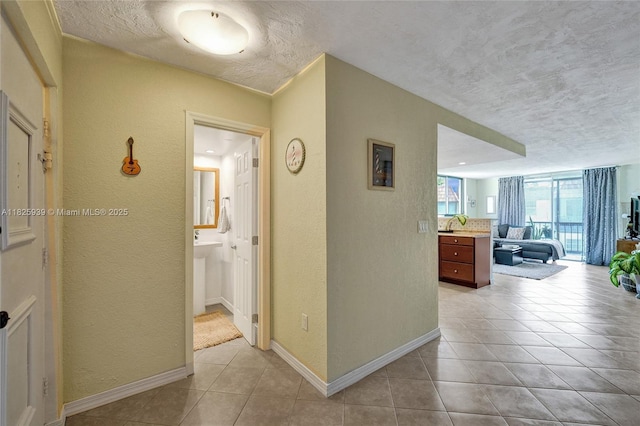 7100 NW 17th St Unit 402, Plantation, FL 33313 - hallway with a textured wall, a textured ceiling, and light tile patterned floors