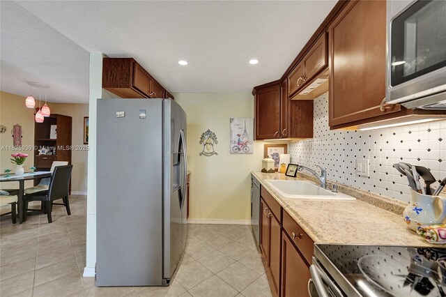 7100 NW 17th St Unit 402, Plantation, FL 33313 - kitchen featuring appliances with stainless steel finishes, light tile patterned floors, light countertops, recessed lighting, and decorative backsplash