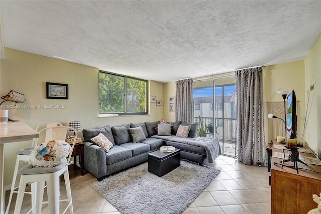 7100 NW 17th St Unit 402, Plantation, FL 33313 - living area featuring light tile patterned flooring, a textured ceiling, and floor to ceiling windows