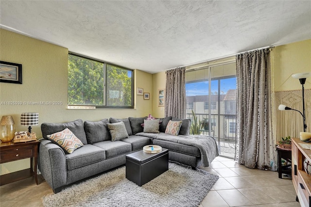 7100 NW 17th St Unit 402, Plantation, FL 33313 - living room with a textured ceiling, tile patterned floors, a wall of windows, and a textured wall