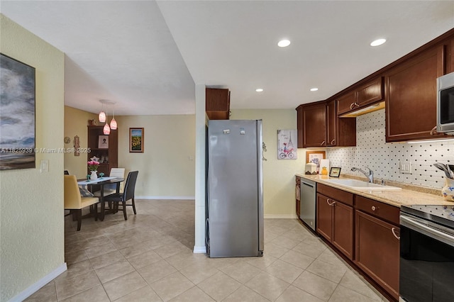 7100 NW 17th St Unit 402, Plantation, FL 33313 - kitchen featuring appliances with stainless steel finishes, light tile patterned floors, backsplash, dark brown cabinetry, and recessed lighting