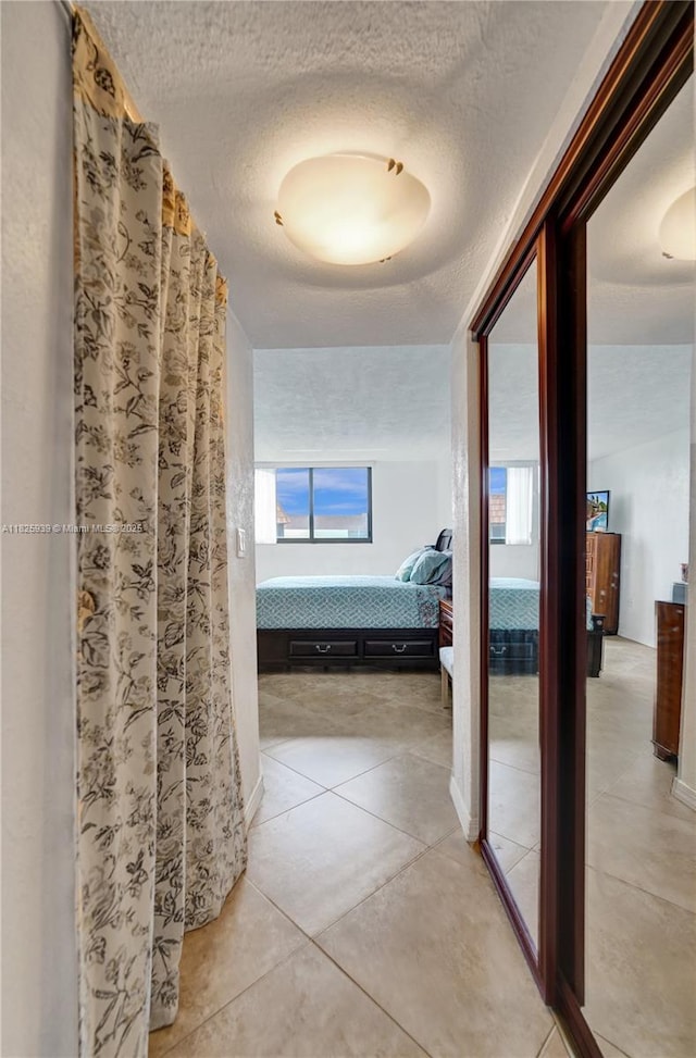 7100 NW 17th St Unit 402, Plantation, FL 33313 - hall featuring a textured ceiling and light tile patterned floors