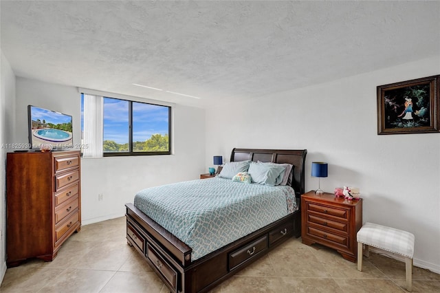 7100 NW 17th St Unit 402, Plantation, FL 33313 - bedroom featuring light tile patterned floors and a textured ceiling
