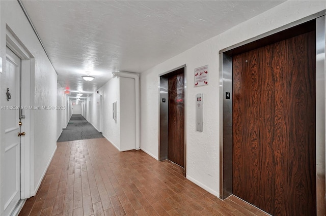 7100 NW 17th St Unit 402, Plantation, FL 33313 - hallway featuring elevator and wood finished floors