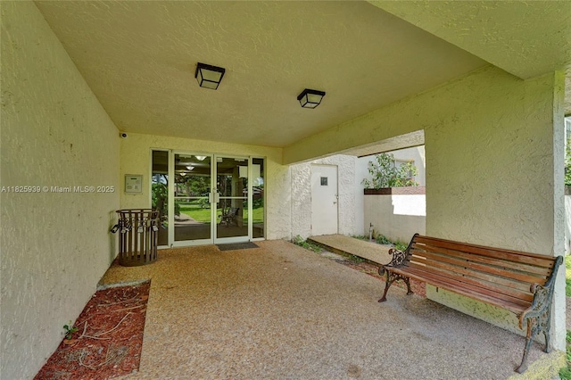 7100 NW 17th St Unit 402, Plantation, FL 33313 - view of exterior entry featuring stucco siding and a patio