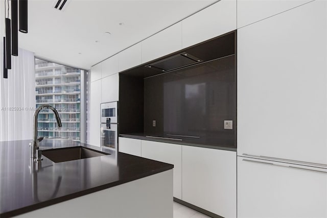 300 Biscayne Blvd Way Unit 2607, Miami, FL 33131 - kitchen with white cabinetry, modern cabinets, and dark countertops