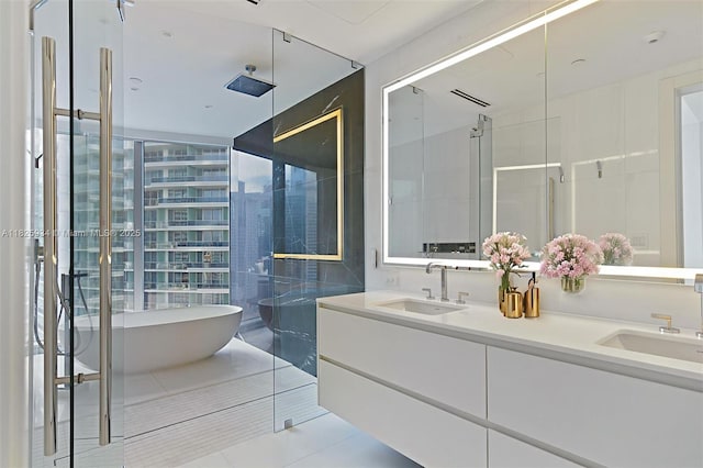 300 Biscayne Blvd Way Unit 2607, Miami, FL 33131 - bathroom featuring a soaking tub, double vanity, an enclosed shower, and tile patterned floors