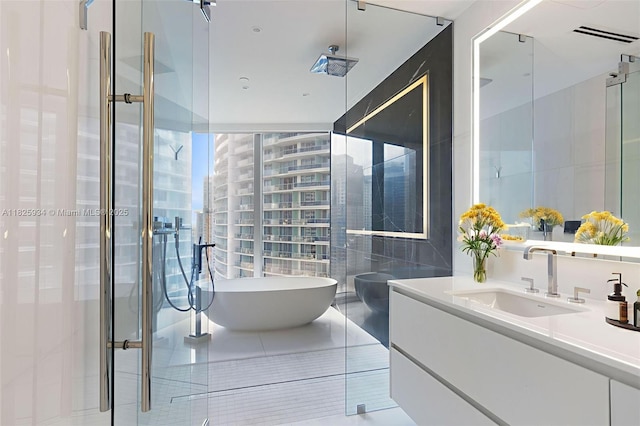 300 Biscayne Blvd Way Unit 2607, Miami, FL 33131 - full bath featuring vanity, tile walls, a stall shower, a freestanding bath, and tile patterned floors