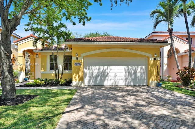 12779 SW 27th St, Miramar, FL 33027 - view of front facade with an attached garage, stucco siding, decorative driveway, and a tile roof