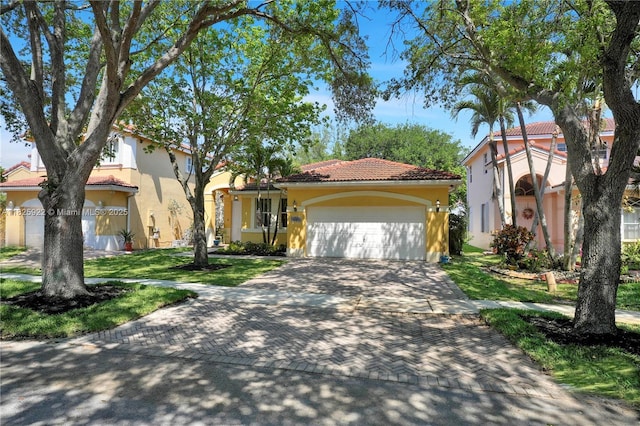 12779 SW 27th St, Miramar, FL 33027 - mediterranean / spanish-style home featuring stucco siding, an attached garage, a tile roof, and decorative driveway