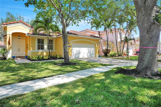 12779 SW 27th St, Miramar, FL 33027 - mediterranean / spanish-style house featuring stucco siding, concrete driveway, an attached garage, a front yard, and a tile roof
