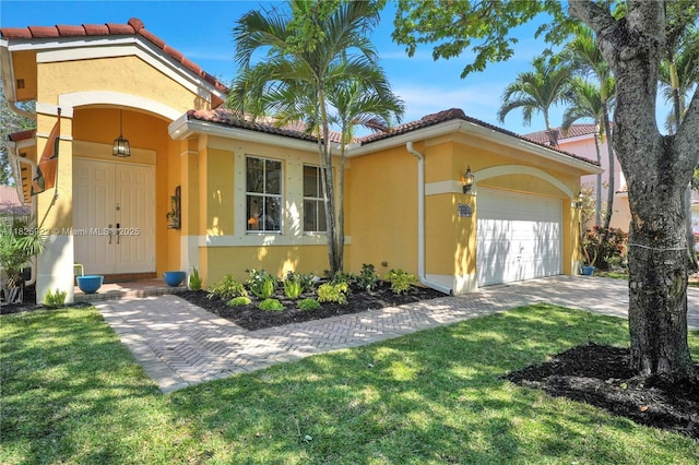 12779 SW 27th St, Miramar, FL 33027 - mediterranean / spanish-style home featuring stucco siding, an attached garage, a tiled roof, and a front yard