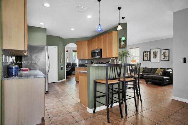 12779 SW 27th St, Miramar, FL 33027 - kitchen with appliances with stainless steel finishes, arched walkways, healthy amount of natural light, light tile patterned floors, and recessed lighting