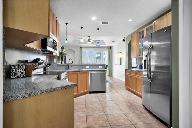 12779 SW 27th St, Miramar, FL 33027 - kitchen with appliances with stainless steel finishes, a peninsula, ceiling fan, light tile patterned floors, and recessed lighting