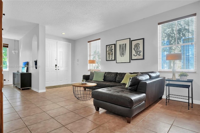 12779 SW 27th St, Miramar, FL 33027 - living room featuring light tile patterned flooring, a textured ceiling, and recessed lighting