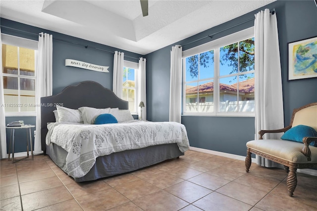 12779 SW 27th St, Miramar, FL 33027 - tiled bedroom featuring a raised ceiling, a ceiling fan, and a water view