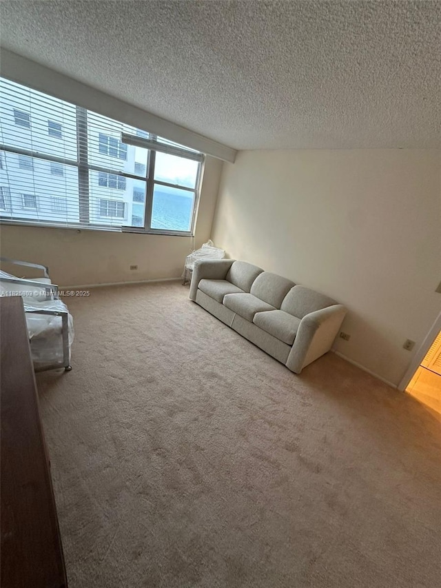 6039 Collins Ave Unit 1625, Miami Beach, FL 33140 - carpeted living area with a textured ceiling
