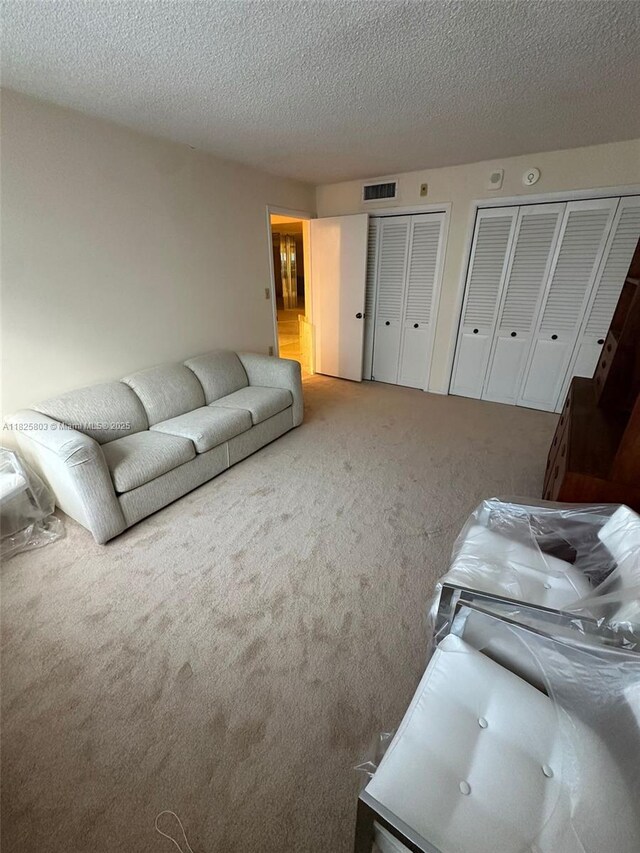 6039 Collins Ave Unit 1625, Miami Beach, FL 33140 - living room featuring carpet and a textured ceiling