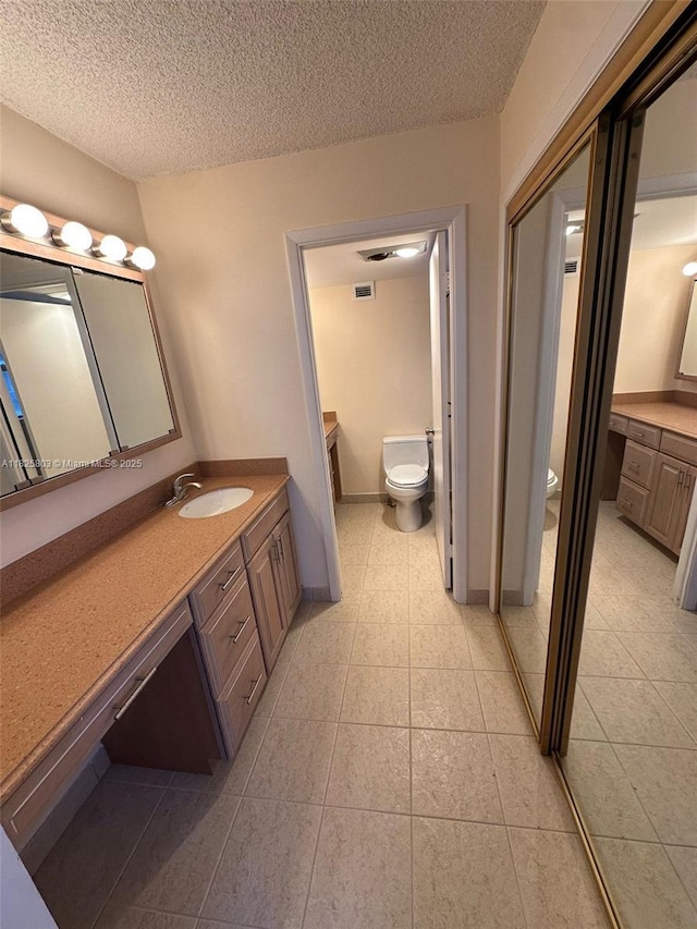 6039 Collins Ave Unit 1625, Miami Beach, FL 33140 - full bathroom with vanity, tile patterned floors, and a textured ceiling