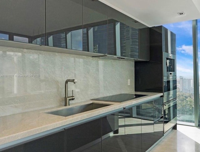 1451 Brickell Ave Unit 2306, Miami, FL 33131 - kitchen featuring tasteful backsplash, floor to ceiling windows, black electric cooktop, and modern cabinets