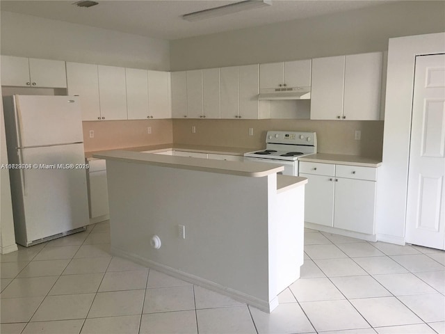 2233 SE 24th Pl Unit 2233, Homestead, FL 33035 - kitchen with white appliances, under cabinet range hood, light countertops, light tile patterned floors, and a kitchen island