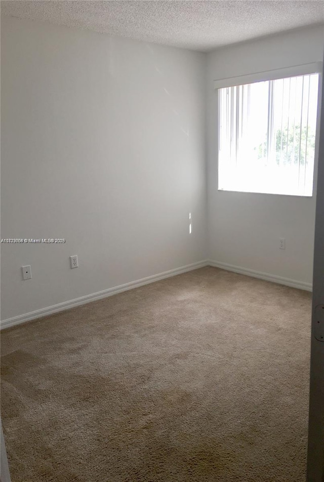 2233 SE 24th Pl Unit 2233, Homestead, FL 33035 - carpeted empty room featuring a textured ceiling and baseboards