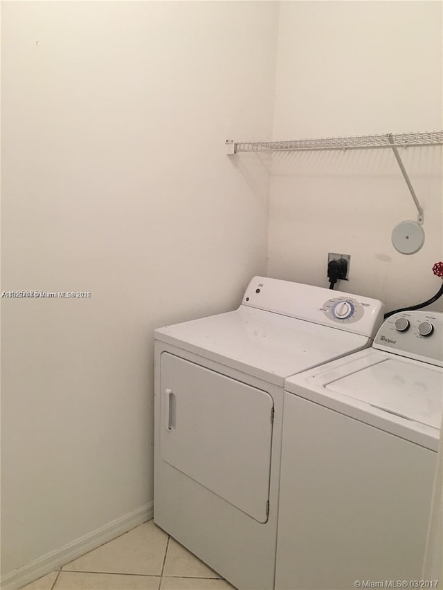 2233 SE 24th Pl Unit 2233, Homestead, FL 33035 - washroom featuring separate washer and dryer and light tile patterned flooring