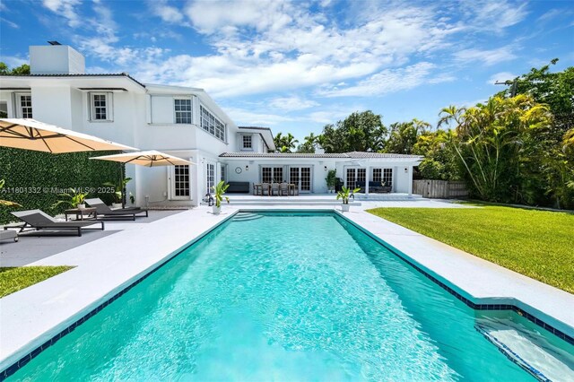 441 Grand Concourse, Miami Shores, FL 33138 - back of house featuring a patio, an outdoor pool, french doors, stucco siding, and a chimney