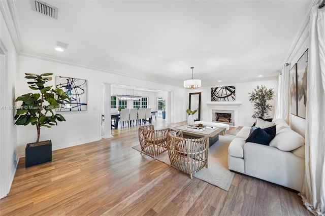 441 Grand Concourse, Miami Shores, FL 33138 - living area with light wood-style floors, a high end fireplace, recessed lighting, and crown molding