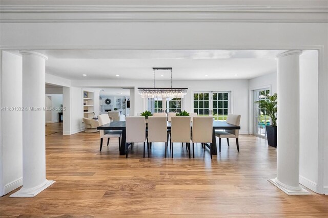 441 Grand Concourse, Miami Shores, FL 33138 - dining space featuring decorative columns, light wood finished floors, built in shelves, and recessed lighting