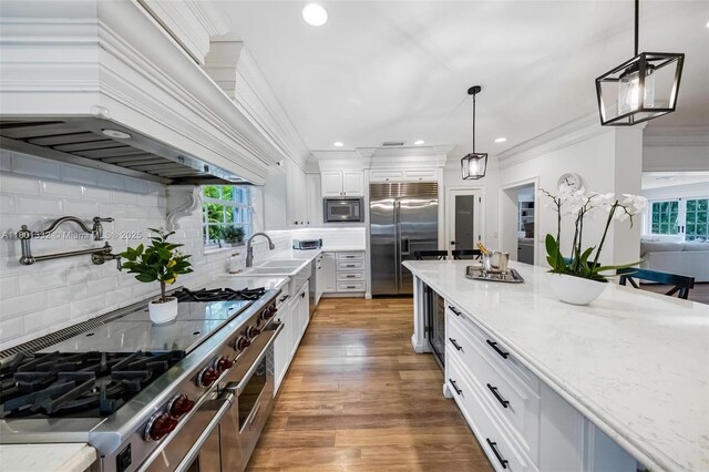441 Grand Concourse, Miami Shores, FL 33138 - kitchen featuring built in appliances, plenty of natural light, decorative backsplash, crown molding, and recessed lighting