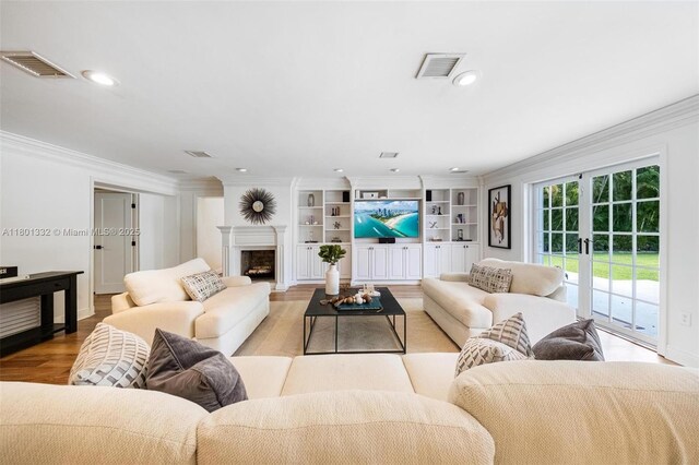 441 Grand Concourse, Miami Shores, FL 33138 - living room featuring light wood-style flooring, crown molding, french doors, a fireplace, and built in features