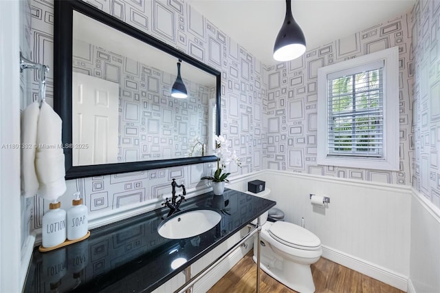 441 Grand Concourse, Miami Shores, FL 33138 - bathroom featuring wood finished floors, wallpapered walls, wainscoting, and vanity