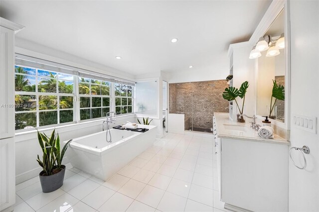 441 Grand Concourse, Miami Shores, FL 33138 - full bathroom featuring vanity, a freestanding bath, brick wall, and tile patterned floors