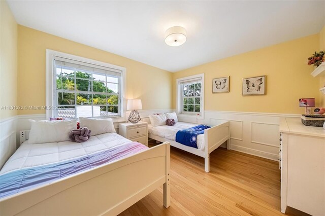 441 Grand Concourse, Miami Shores, FL 33138 - bedroom with light wood-style flooring and a wainscoted wall