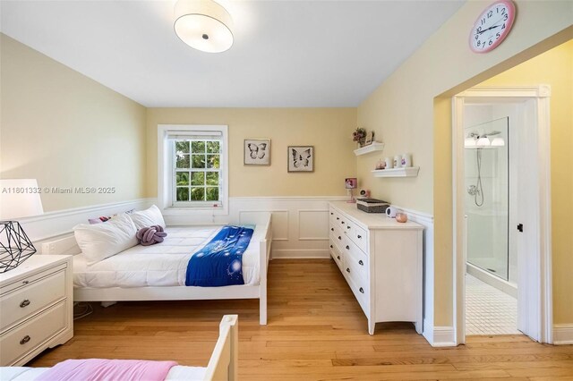 441 Grand Concourse, Miami Shores, FL 33138 - bedroom with light wood-style flooring and a wainscoted wall