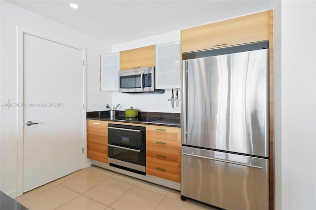 3301 NE 1st Ave Unit H2104, Miami, FL 33137 - kitchen with appliances with stainless steel finishes, dark countertops, light tile patterned floors, recessed lighting, and modern cabinets