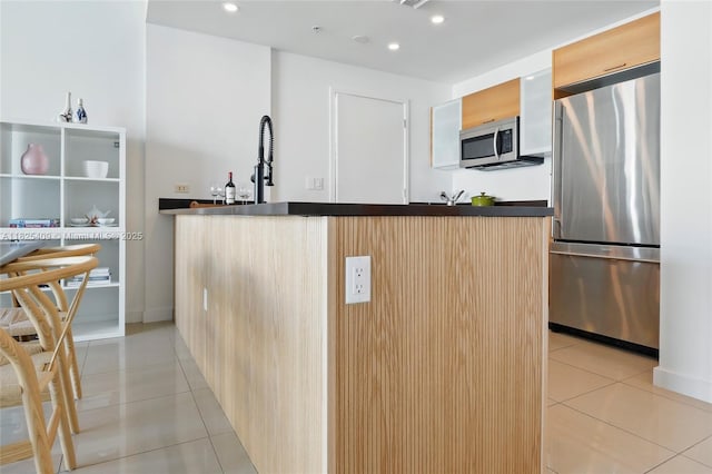 3301 NE 1st Ave Unit H2104, Miami, FL 33137 - kitchen featuring appliances with stainless steel finishes, light tile patterned flooring, modern cabinets, dark countertops, and recessed lighting