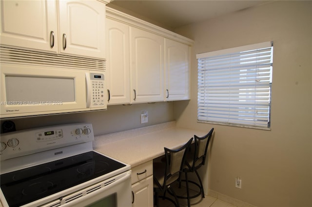 9420 Poinciana Pl Unit 115, Davie, FL 33324 - kitchen with white appliances, white cabinetry, and light countertops