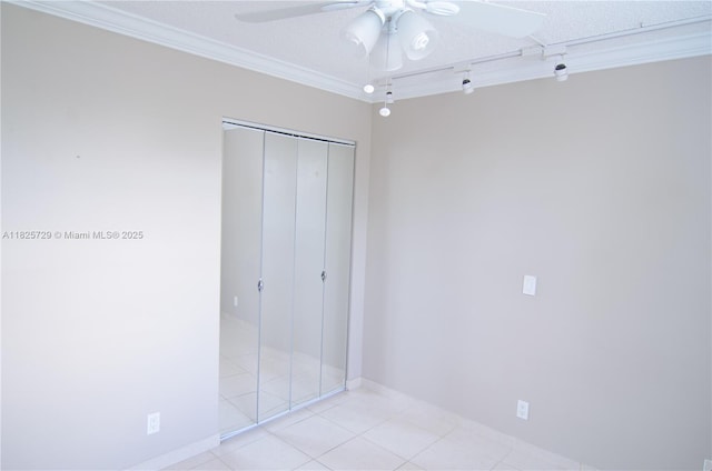 9420 Poinciana Pl Unit 115, Davie, FL 33324 - unfurnished bedroom with crown molding, a closet, light tile patterned floors, and ceiling fan