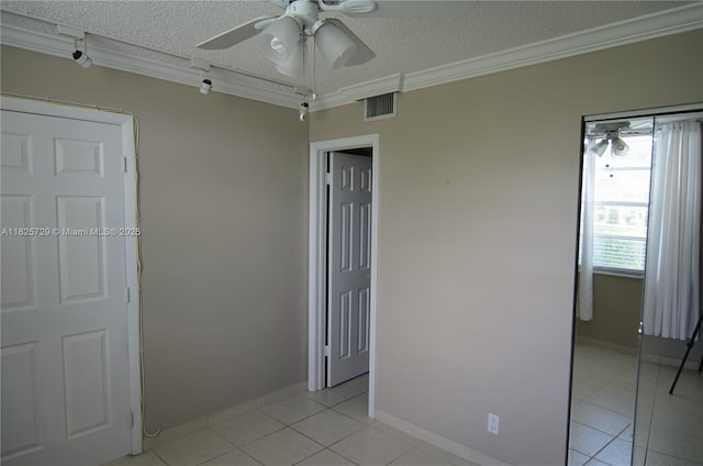 9420 Poinciana Pl Unit 115, Davie, FL 33324 - spare room featuring light tile patterned floors, a ceiling fan, ornamental molding, and a textured ceiling