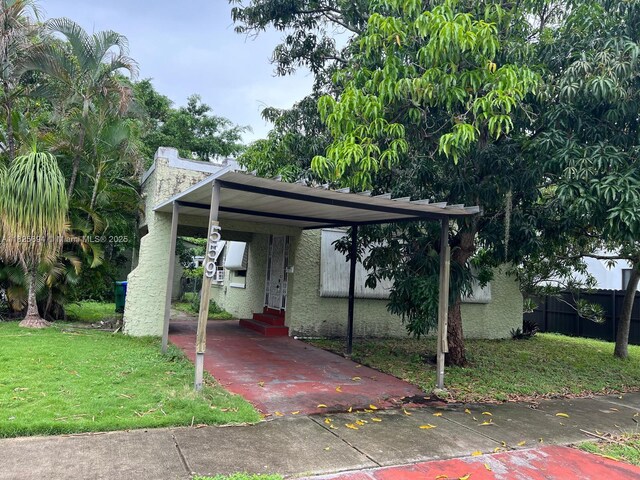559 NW 44th St, Miami, FL 33127 - view of vehicle parking with entry steps and a detached carport