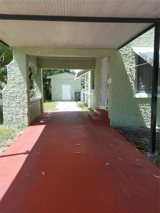559 NW 44th St, Miami, FL 33127 - view of patio featuring a carport and entry steps